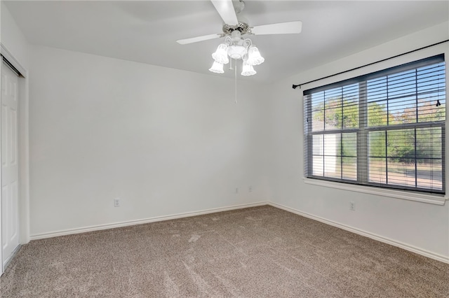 spare room featuring carpet and ceiling fan