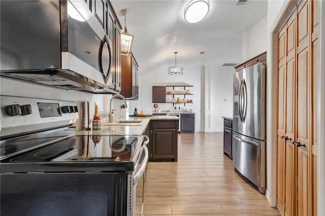 kitchen featuring dark brown cabinetry, sink, pendant lighting, appliances with stainless steel finishes, and light wood-type flooring