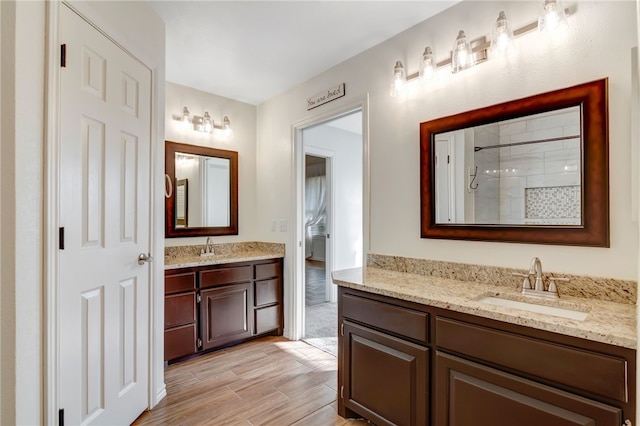 bathroom with vanity, hardwood / wood-style flooring, and walk in shower