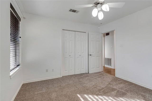 unfurnished bedroom featuring carpet flooring, ceiling fan, and a closet