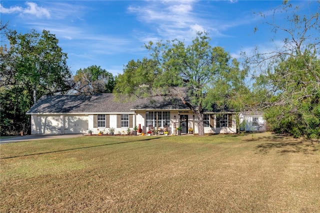 single story home featuring a garage and a front lawn