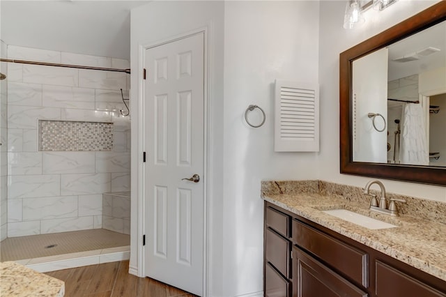 bathroom with hardwood / wood-style floors, vanity, and a shower with curtain