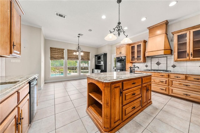 kitchen featuring a notable chandelier, pendant lighting, a kitchen island with sink, custom range hood, and ornamental molding