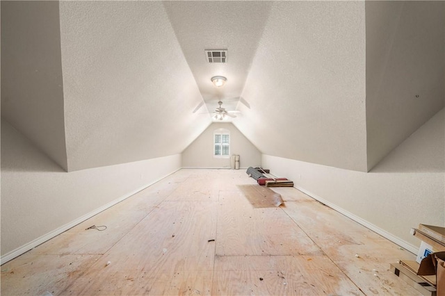 bonus room with a textured ceiling, ceiling fan, and lofted ceiling