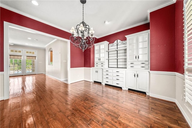 interior space featuring a chandelier, dark hardwood / wood-style floors, and ornamental molding