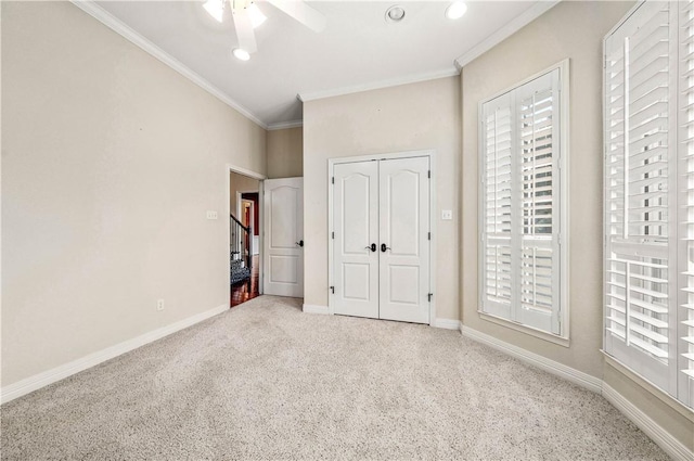 unfurnished bedroom with ceiling fan, carpet floors, and multiple windows