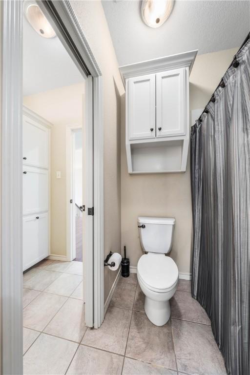 bathroom with tile patterned flooring and toilet