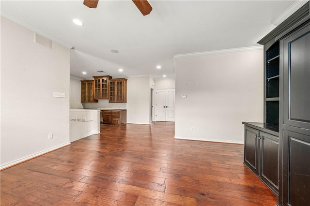 unfurnished living room with ceiling fan, dark hardwood / wood-style floors, and ornamental molding