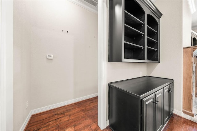 bar featuring dark hardwood / wood-style flooring and ornamental molding