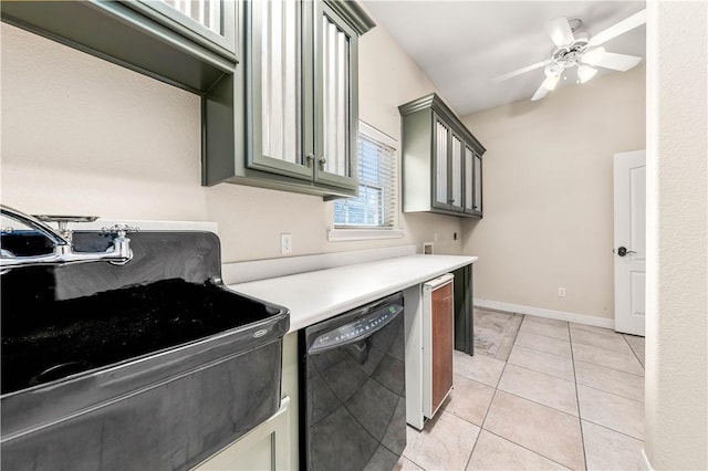 kitchen with light tile patterned floors, black dishwasher, and ceiling fan