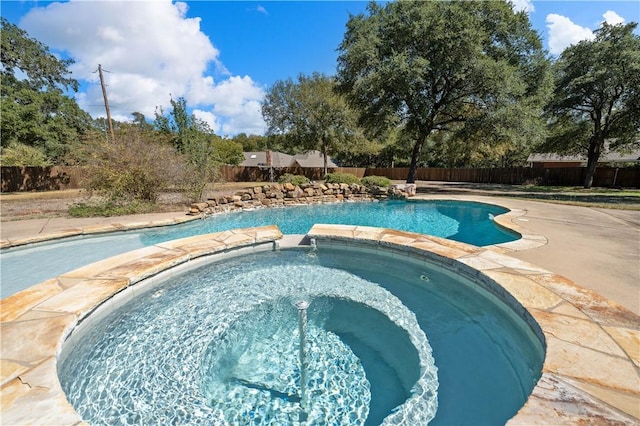 view of pool with an in ground hot tub