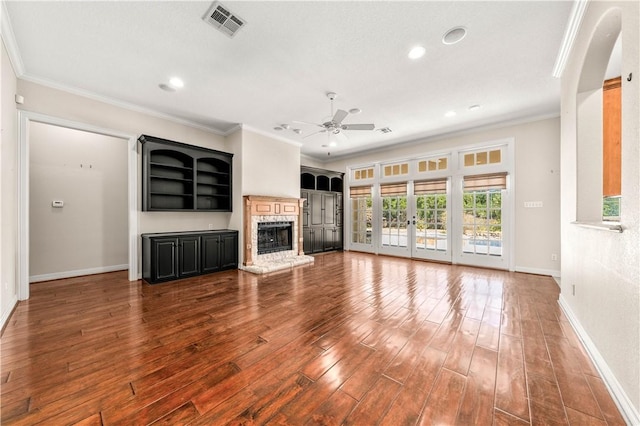 unfurnished living room with ceiling fan, hardwood / wood-style floors, french doors, and ornamental molding