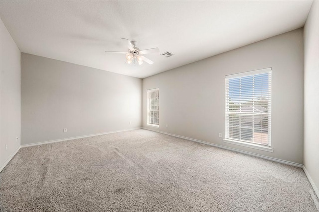 unfurnished room featuring ceiling fan and carpet floors