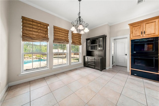 kitchen with light tile patterned floors, crown molding, double oven, and an inviting chandelier