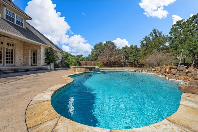 view of pool with pool water feature and a patio