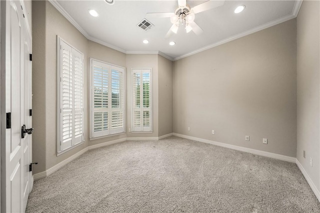 spare room with ceiling fan, light colored carpet, and ornamental molding