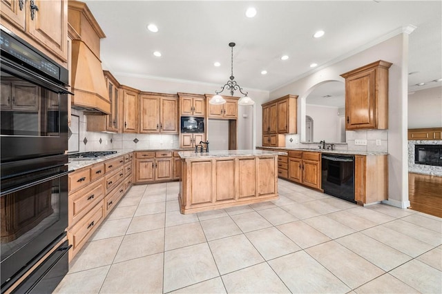 kitchen featuring hanging light fixtures, a kitchen island, premium range hood, light tile patterned flooring, and black appliances