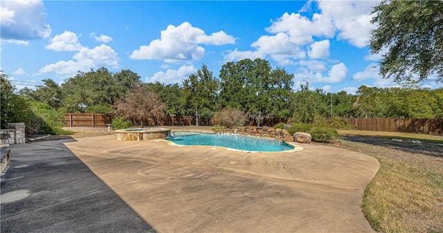 view of swimming pool with a patio area and an in ground hot tub