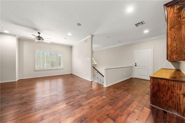 spare room with ceiling fan, dark hardwood / wood-style flooring, and ornamental molding