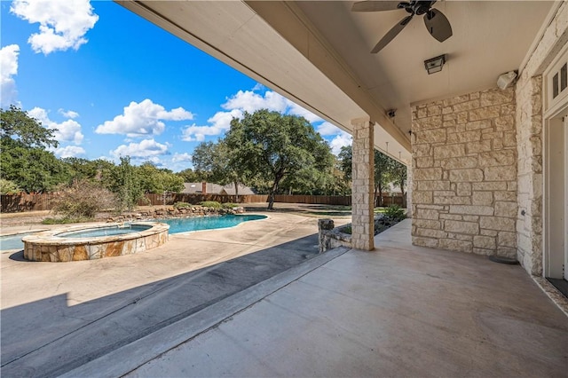 view of patio with ceiling fan and a swimming pool with hot tub