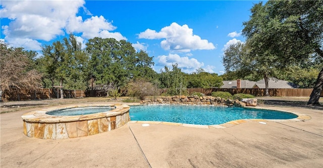 view of swimming pool with a patio area and an in ground hot tub