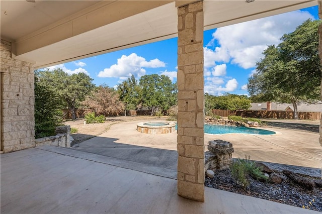 view of patio / terrace featuring a pool with hot tub