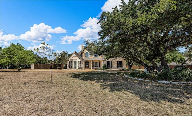 view of front of home featuring covered porch and a front lawn