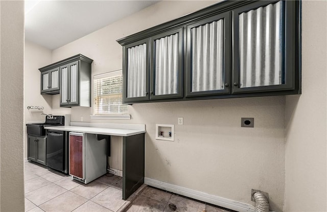 washroom with electric dryer hookup, light tile patterned floors, and hookup for a washing machine