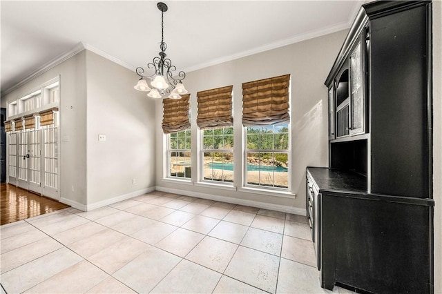 unfurnished dining area featuring light tile patterned floors, crown molding, and an inviting chandelier