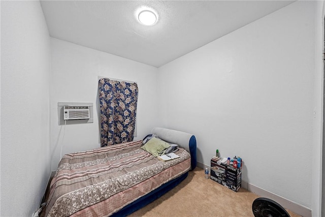 carpeted bedroom with a wall unit AC