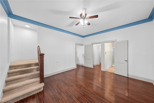 interior space with ceiling fan, crown molding, and dark wood-type flooring