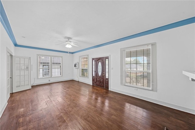 unfurnished living room featuring dark hardwood / wood-style floors, ceiling fan, and crown molding