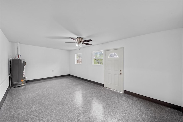 unfurnished living room with water heater and ceiling fan