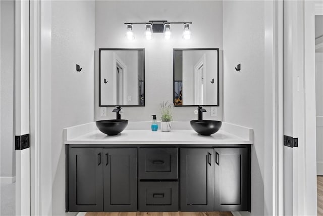 bathroom with hardwood / wood-style floors and vanity