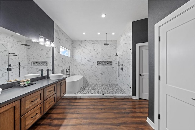 bathroom with vanity, shower with separate bathtub, wood-type flooring, and tile walls