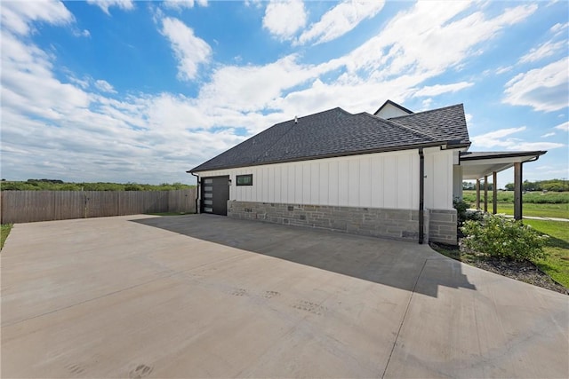 view of side of home featuring a garage