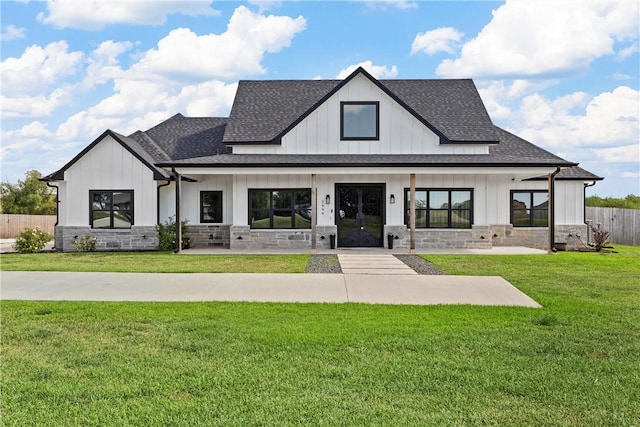 exterior space featuring covered porch and a front yard