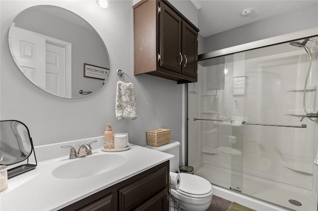 bathroom featuring vanity, toilet, and walk in shower