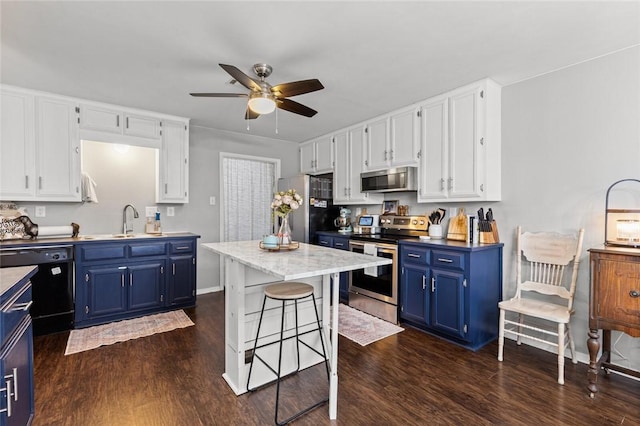 kitchen featuring blue cabinetry, stainless steel appliances, dark hardwood / wood-style flooring, and sink