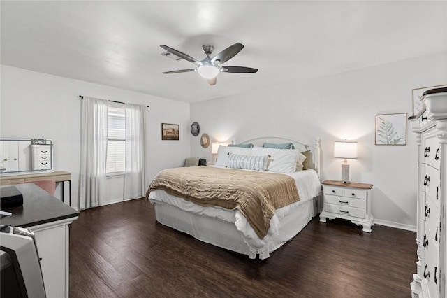 bedroom with dark hardwood / wood-style floors and ceiling fan