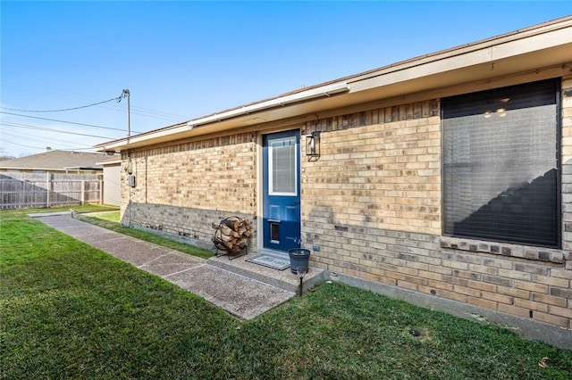 doorway to property with a yard