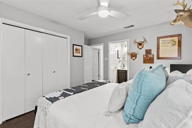 bedroom featuring ensuite bathroom, dark wood-type flooring, ceiling fan, and a closet