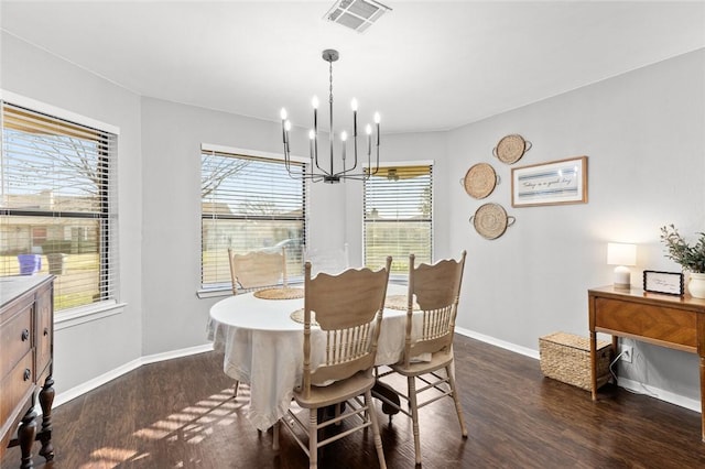 dining area featuring dark wood-type flooring and a notable chandelier