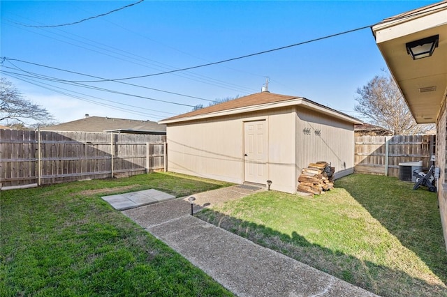 view of yard with central air condition unit and a storage shed