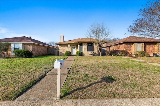 ranch-style home featuring a front yard