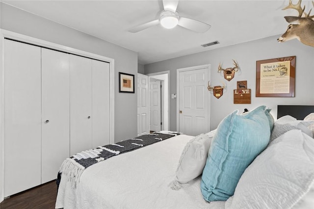 bedroom featuring ceiling fan, dark hardwood / wood-style flooring, and a closet