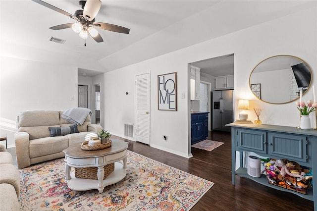 living room with dark hardwood / wood-style floors and ceiling fan