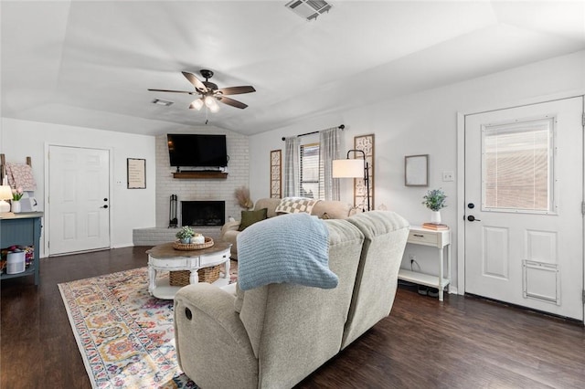 living room with ceiling fan, lofted ceiling, dark hardwood / wood-style floors, and a fireplace