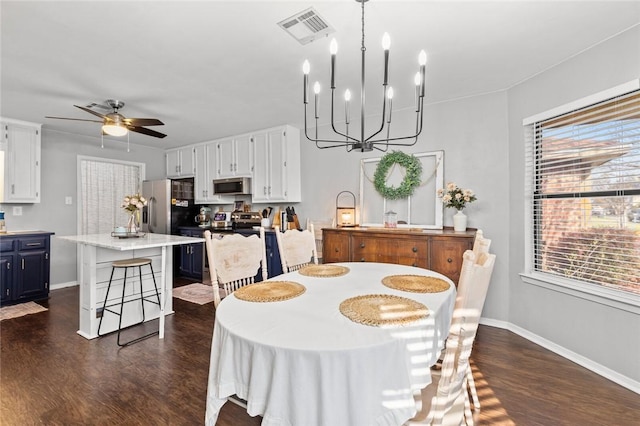 dining space featuring ceiling fan with notable chandelier and dark hardwood / wood-style flooring