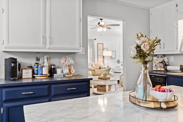 interior space with blue cabinets, white cabinetry, dark stone countertops, dishwasher, and ceiling fan